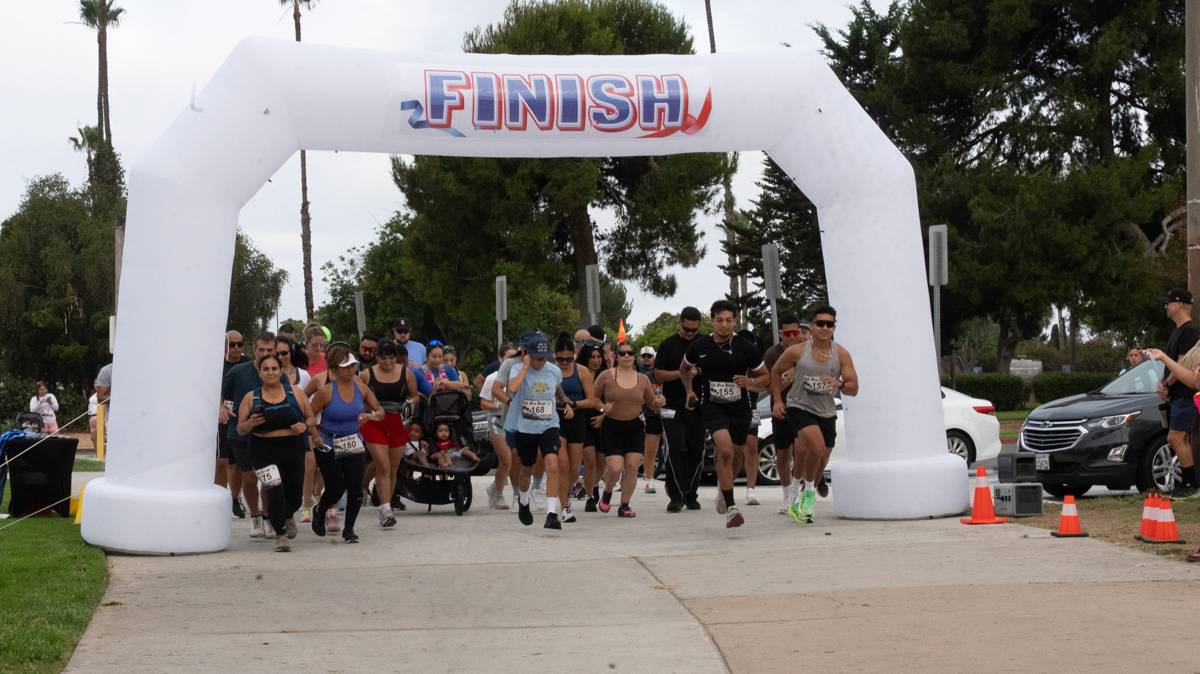Runners crossing the finish line arch