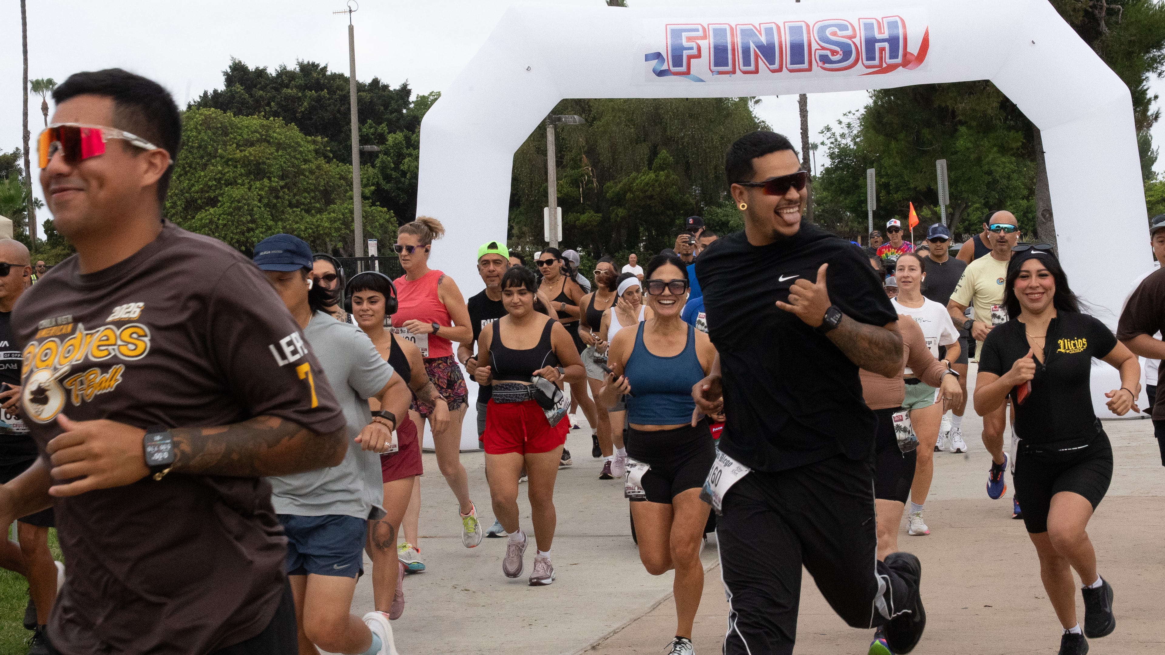 Community runners smiling at the finish line